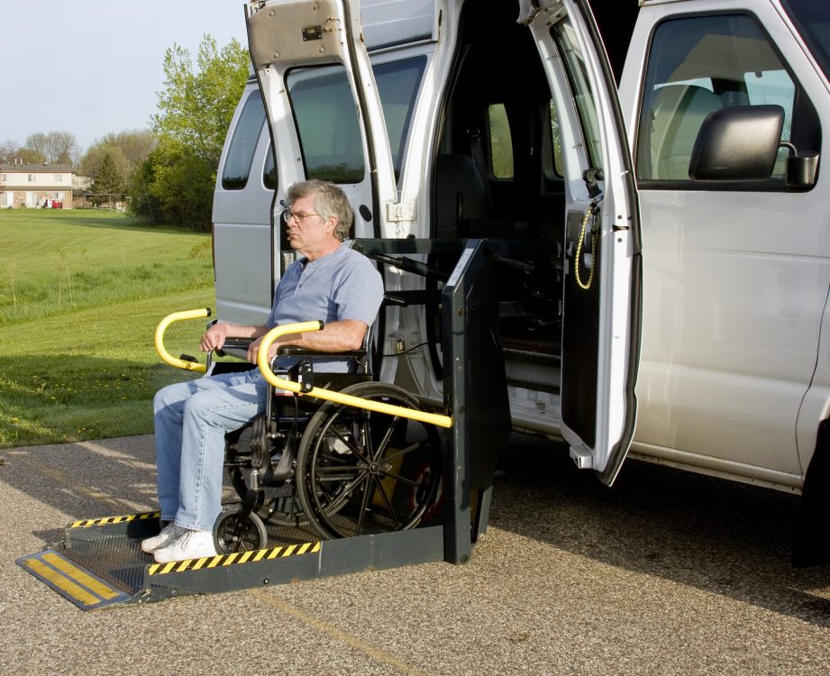 Handicap Wheelchair Lift handicap van with a man in a wheelchair on a lift